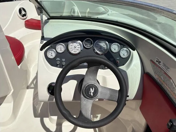 Slide: The Image of 2007 Sea Ray 195 Sport boat dashboard with steering wheel and gauges. - 9
