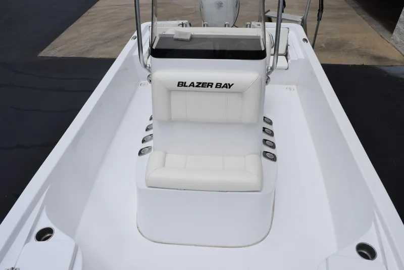 Slide: The Image of 2017 Blazer Bay 2200 boat interior with white seating and console. - 12
