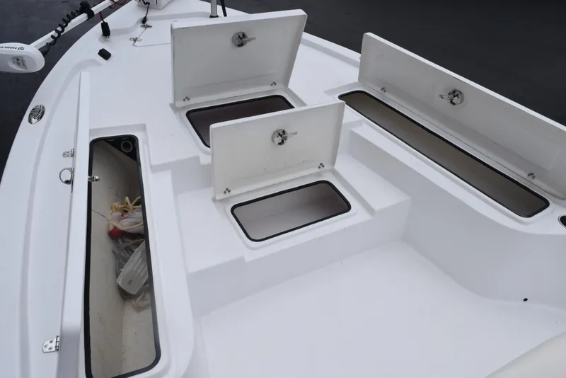Slide: The Image of 2017 Blazer Bay 2200 boat storage compartments open on deck. - 15