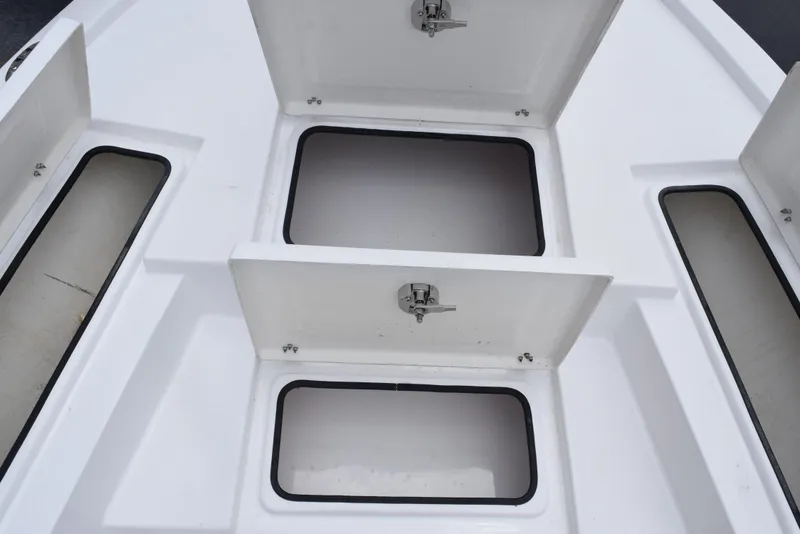 Slide: The Image of Open storage compartments on a 2017 Blazer Bay 2200 boat deck. - 16