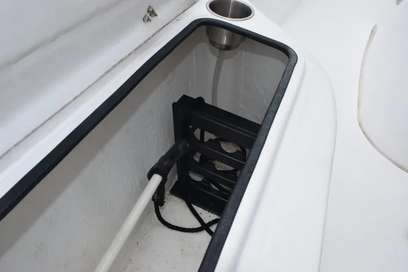 Slide: The Image of Storage compartment in 2017 Blazer Bay 2200 boat with cup holder and equipment. - 18