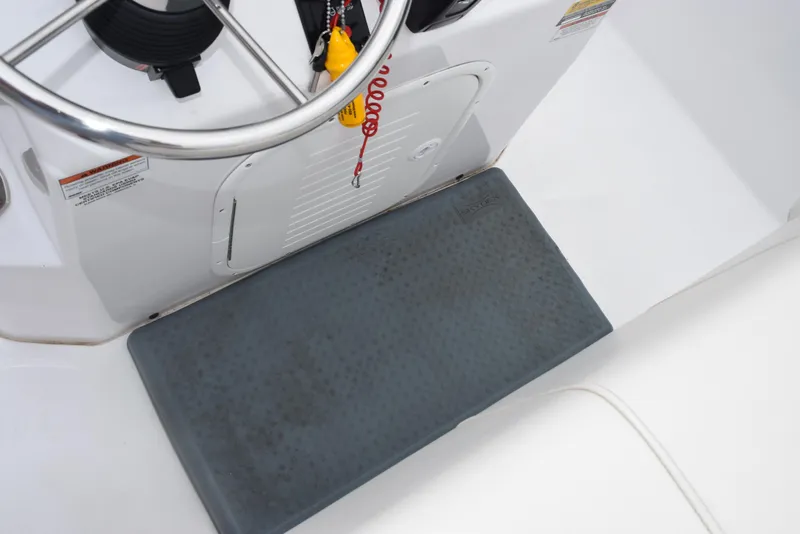 Slide: The Image of 2017 Blazer Bay 2200 boat console with steering wheel and cushioned footrest. - 23