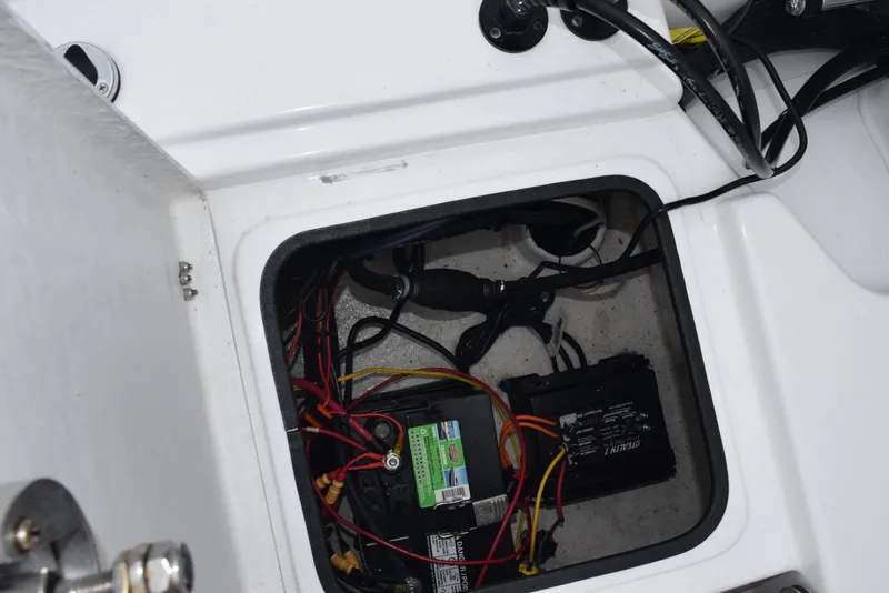 Slide: The Image of 2017 Blazer Bay 2200 boat battery compartment with wiring and components. - 27