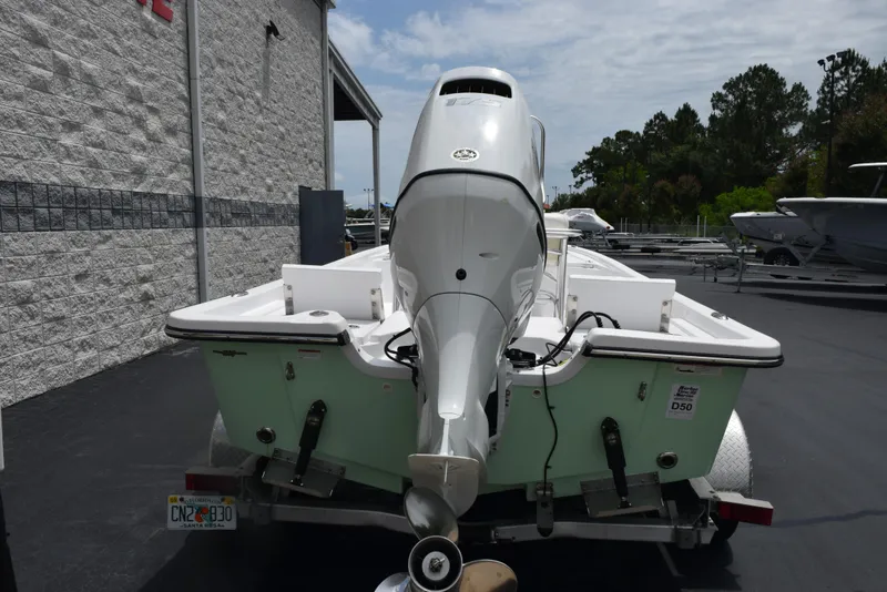 Slide: The Image of 2017 Blazer Bay 2200 boat with outboard motor on trailer, parked outdoors. - 5