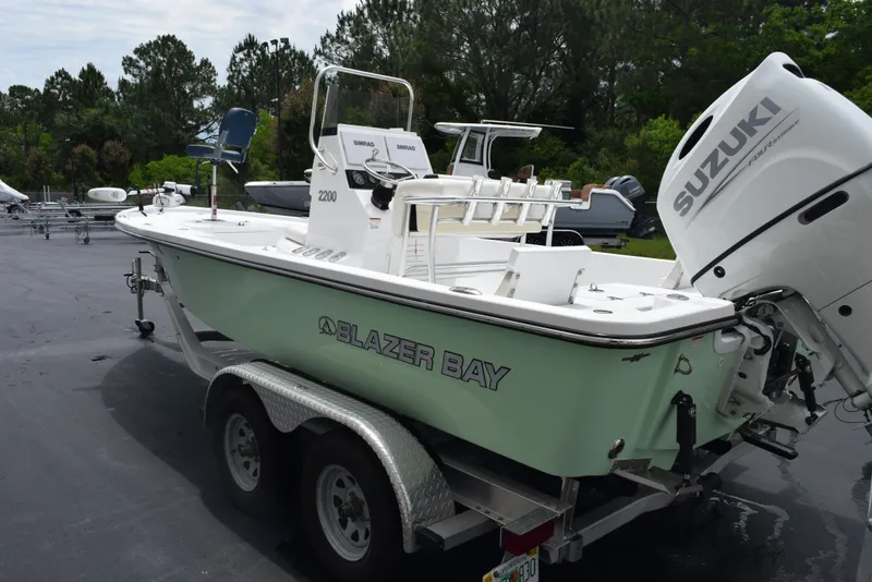 Slide: The Image of 2017 Blazer Bay 2200 boat on trailer with Suzuki outboard motor. - 6