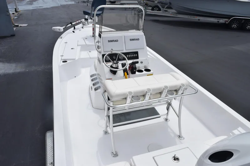 Slide: The Image of 2017 Blazer Bay 2200 boat with steering console and seating, docked on a marina. - 7