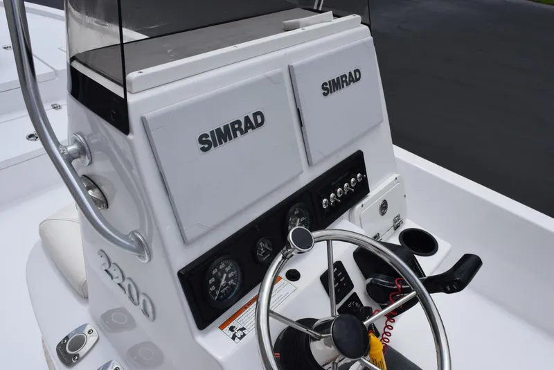 Slide: The Image of 2017 Blazer Bay 2200 boat console with Simrad electronics and steering wheel. - 8