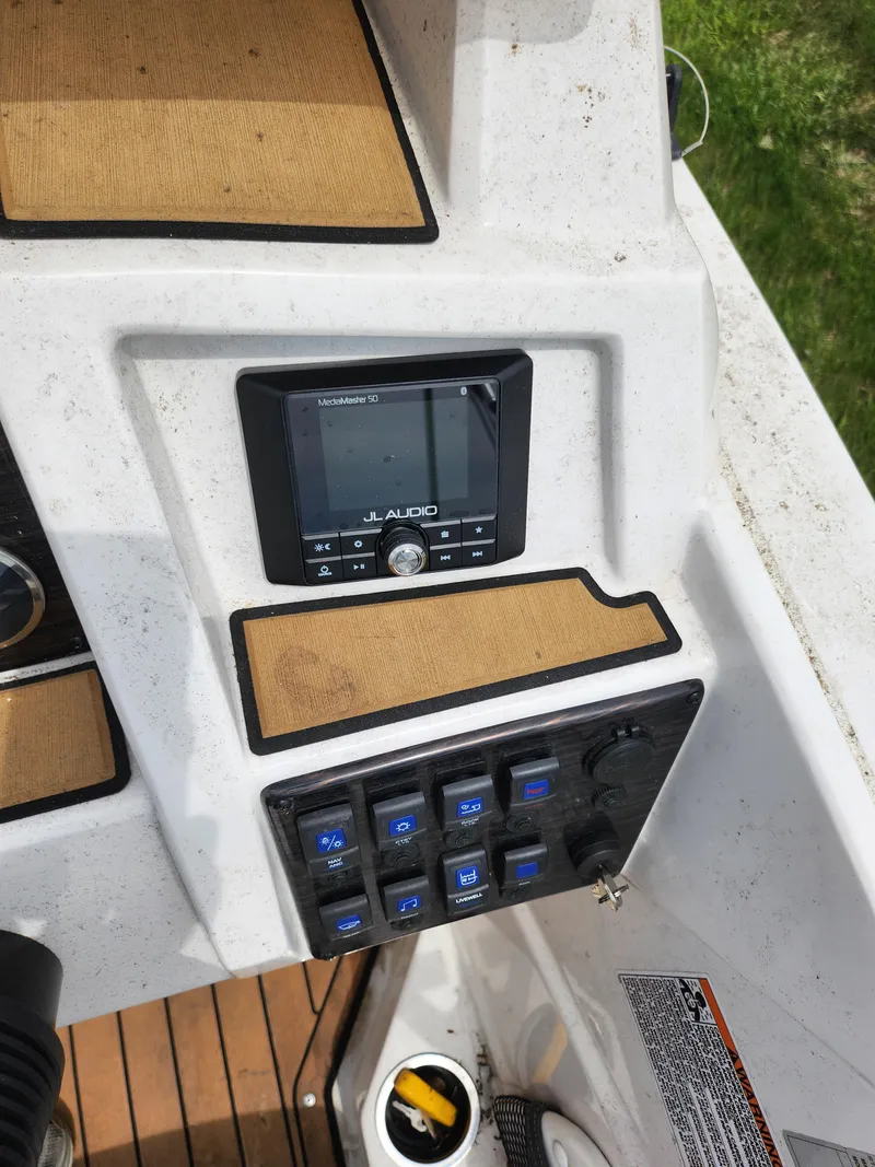 Slide: The Image of Control panel of 2021 Starcraft SVX 191 OB boat with audio system and switches. - 14