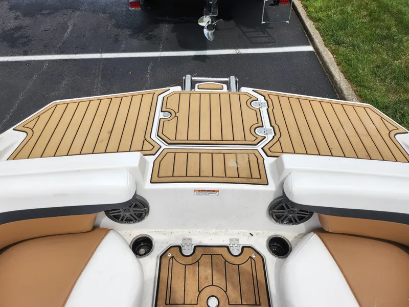 Slide: The Image of 2021 Starcraft SVX 191 OB boat with tan and white seating, wood-patterned deck. - 17