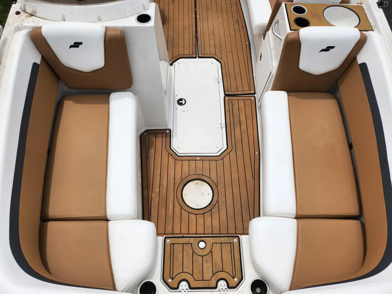 Slide: The Image of 2021 Starcraft SVX 191 OB boat interior with tan and white seating, wood-style flooring. - 18
