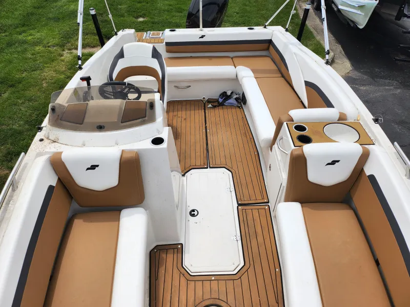 Slide: The Image of 2021 Starcraft SVX 191 OB boat interior with tan and white seating, wood flooring. - 19