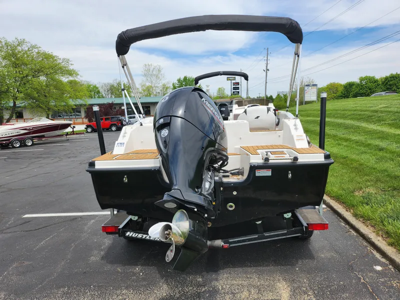 Slide: The Image of 2021 Starcraft SVX 191 OB boat with outboard motor, parked on pavement. - 2