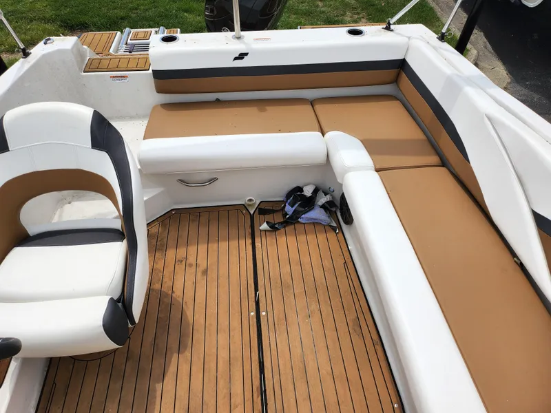 Slide: The Image of 2021 Starcraft SVX 191 OB boat interior with tan and white seating, wooden flooring. - 22