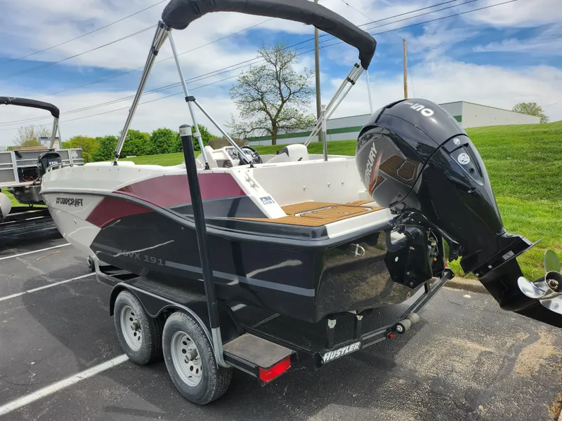 Slide: The Image of 2021 Starcraft SVX 191 OB boat on trailer with outboard motor in parking lot. - 4