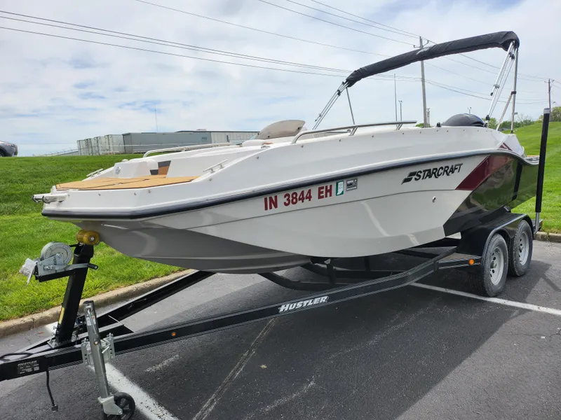 Slide: The Image of 2021 Starcraft SVX 191 OB boat on trailer, parked outdoors. - 6