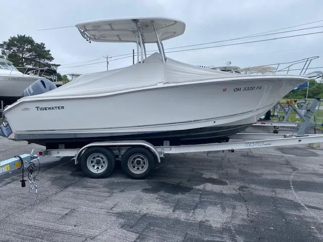 Slide: The Image of 2014 Tidewater 216 CC Adventure boat on trailer, covered and parked outdoors. - 0