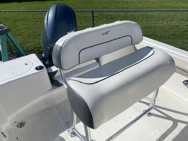 Slide: The Image of 2014 Tidewater 216 CC Adventure boat seat with engine in background. - 10