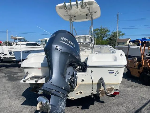 Slide: The Image of 2014 Tidewater 216 CC Adventure boat with Yamaha outboard motor, parked outdoors. - 13