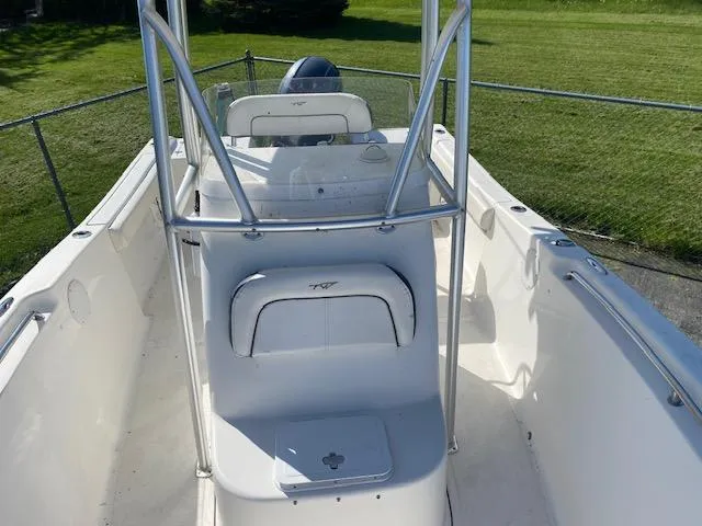 Slide: The Image of 2014 Tidewater 216 CC Adventure boat, white interior, center console, outdoor setting. - 6