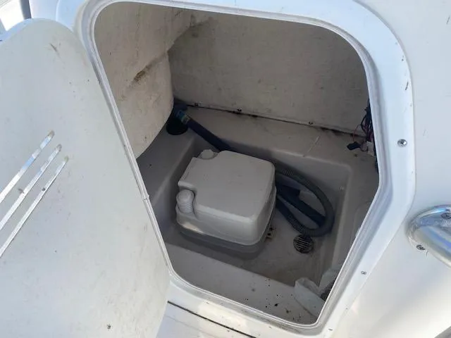 Slide: The Image of Portable toilet in 2014 Tidewater 216 CC Adventure boat compartment. - 8