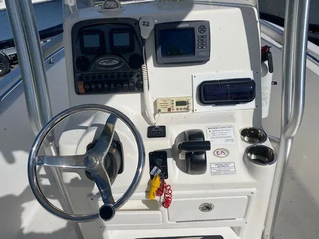 Slide: The Image of 2014 Tidewater 216 CC Adventure boat console with steering wheel and navigation controls. - 9