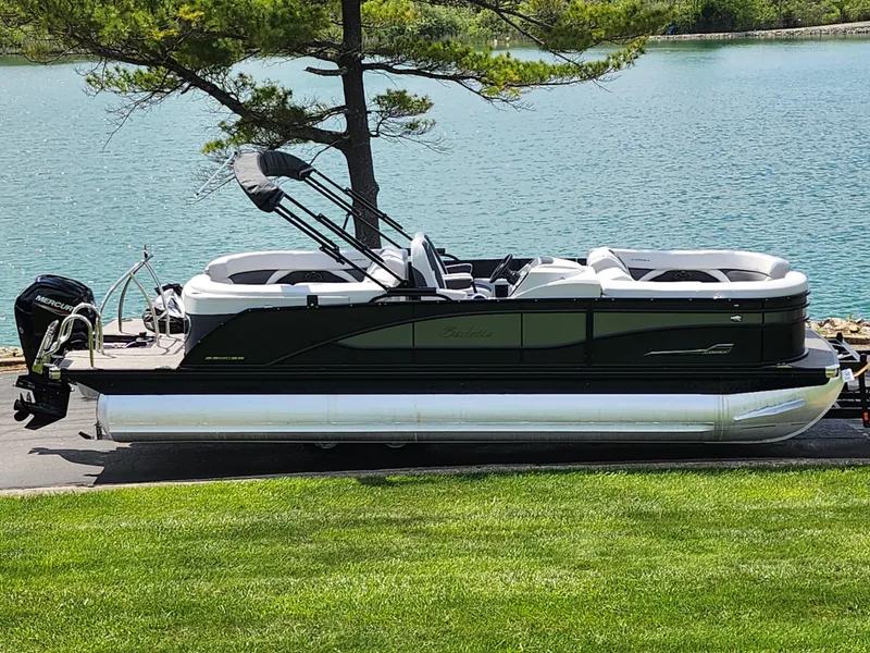 Slide: The Image of 2021 Barletta CORSA 23QC pontoon boat by a serene lake. - 0