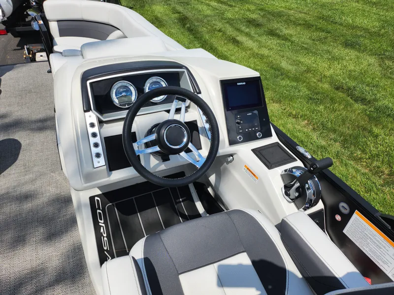 Slide: The Image of 2021 Barletta CORSA 23QC boat dashboard with steering wheel and control panel. - 19