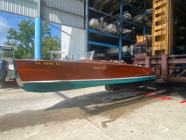 Slide: The Image of A 2000 Grand Craft Classic Runabout boat in a storage facility. - 1