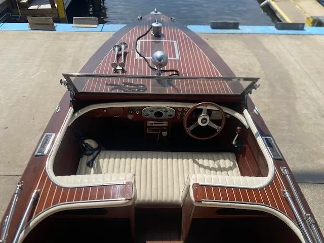 Slide: The Image of Grand Craft Classic Runabout 2000 with wooden deck and vintage steering, docked by the water. - 11