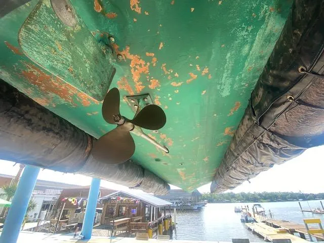 Slide: The Image of Underside of 2000 Grand Craft Classic Runabout with visible propeller and weathered paint. - 17