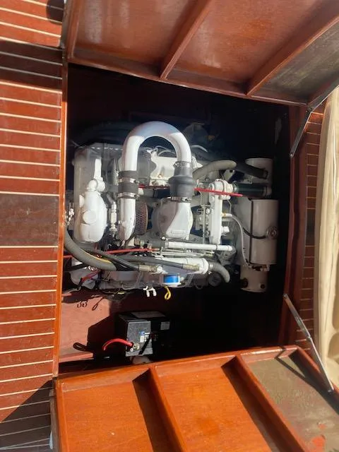Slide: The Image of Engine compartment of a 2000 Grand Craft Classic Runabout boat, showcasing detailed mechanical components. - 21