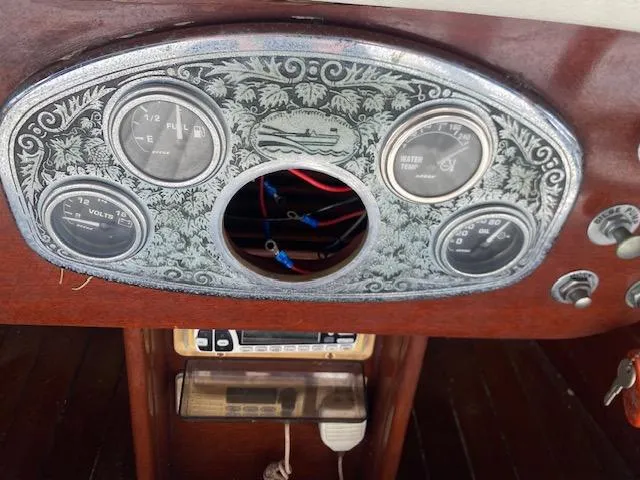 Slide: The Image of Dashboard of a 2000 Grand Craft Classic Runabout with vintage gauges and intricate design. - 24