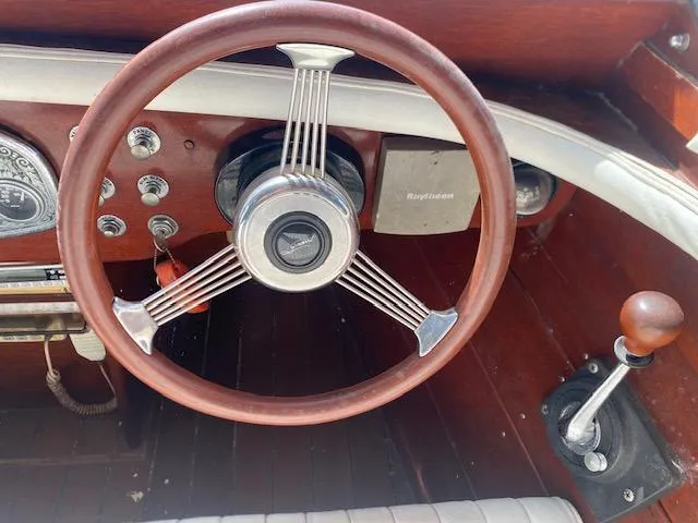 Slide: The Image of Steering wheel and controls of a 2000 Grand Craft Classic Runabout boat. - 25