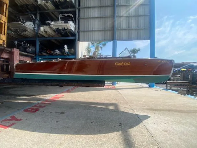 Slide: The Image of 2000 Grand Craft Classic Runabout boat in storage facility, side view. - 4