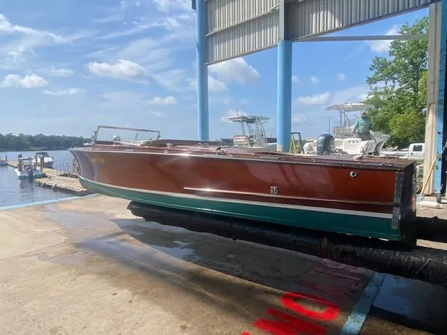 Slide: The Image of 2000 Grand Craft Classic Runabout boat on a dock under a blue sky. - 6