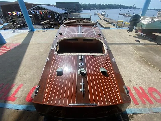Slide: The Image of Classic 2000 Grand Craft Runabout with wooden deck, docked by the waterfront. - 8