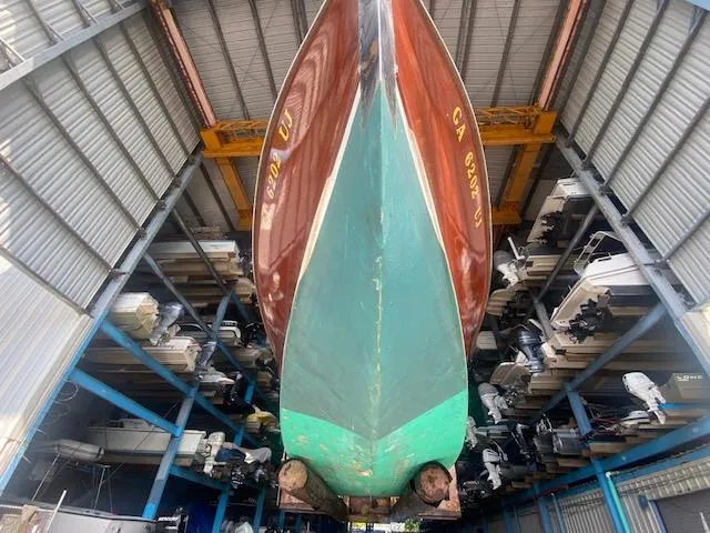 Slide: The Image of Grand Craft Classic Runabout 2000 stored in a boat warehouse, viewed from below. - 9