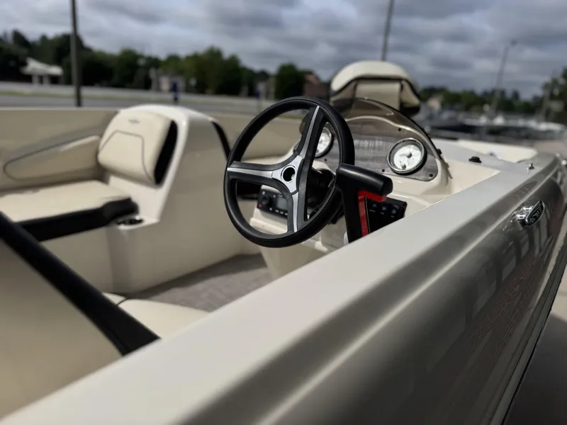 Slide: The Image of 2021 Stingray 182 SC boat with Yamaha 115 outboard motor in a parking lot. - 4