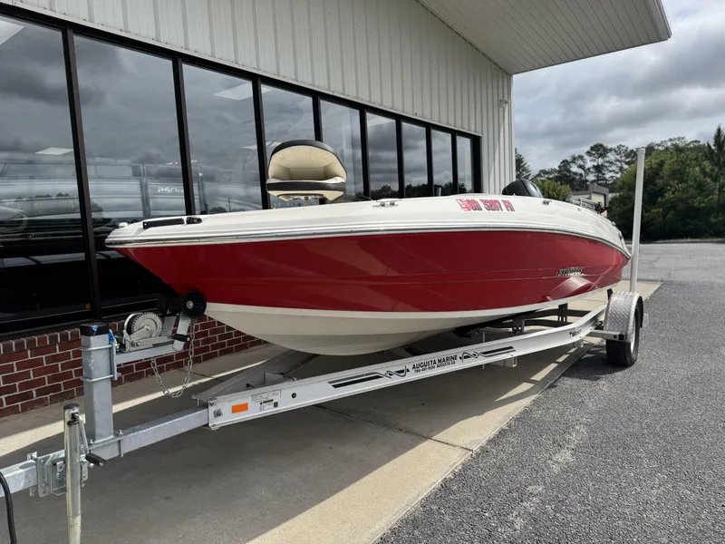 Slide: The Image of 2021 Stingray 182 SC boat with Yamaha 115 engine, parked outdoors. - 5