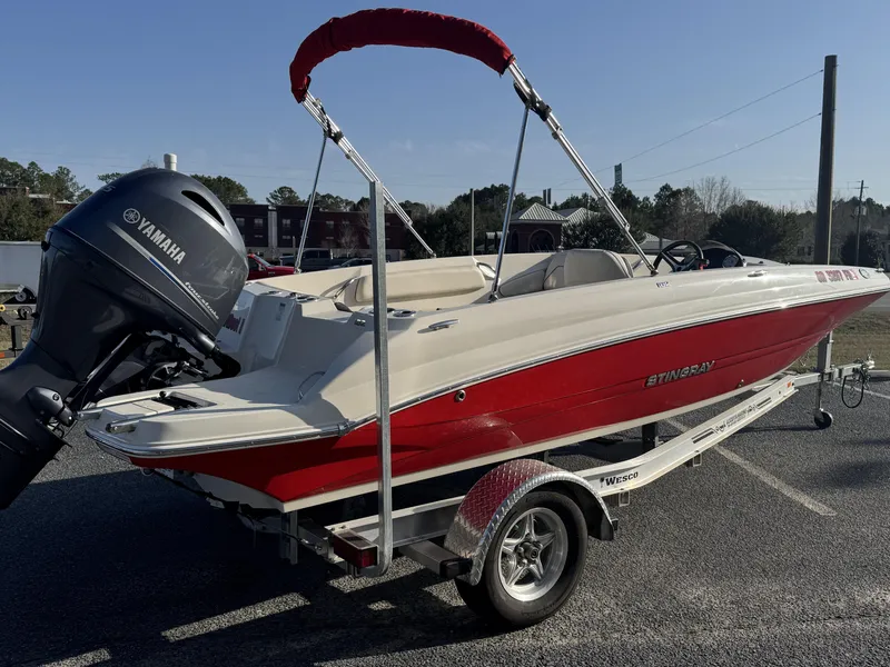 Slide: The Image of 2021 Stingray 182 SC boat with Yamaha engine on trailer, red and white design. - 6