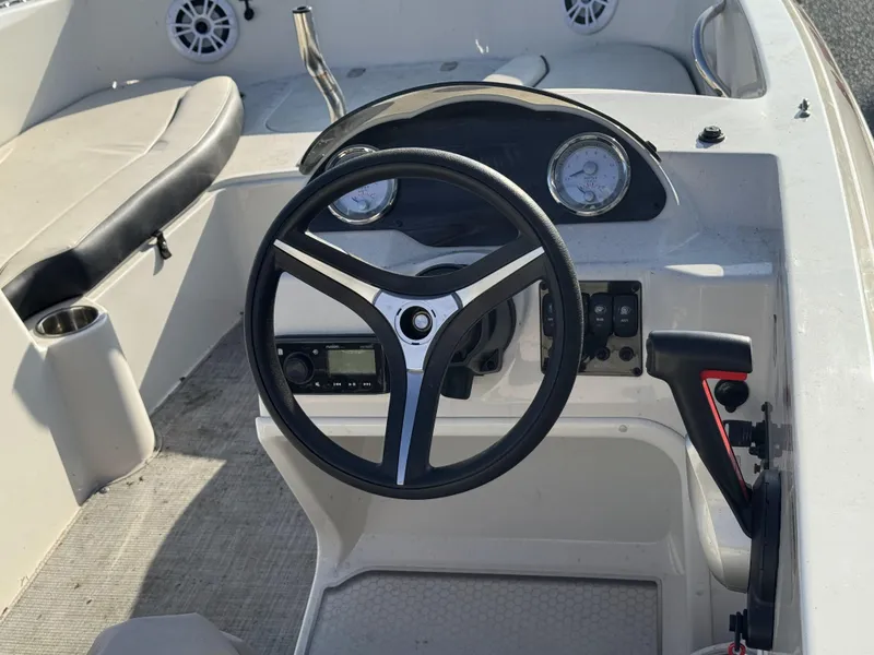 Slide: The Image of 2021 Stingray 182 SC boat cockpit with steering wheel and control panel. - 7