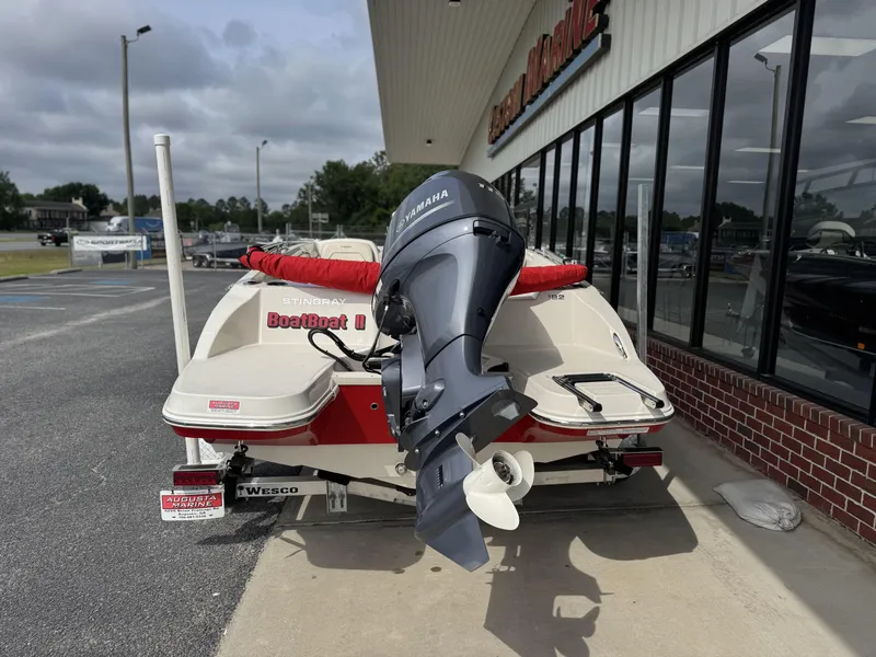 Slide: The Image of 2021 Stingray 182 SC boat with Yamaha outboard motor, parked outside a dealership. - 9