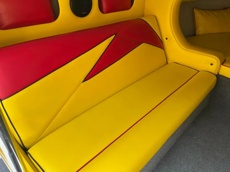 Slide: The Image of Yellow and red interior seating of a 2006 Kachina Drone 26 boat. - 13