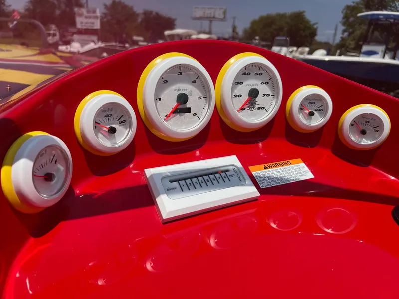 Slide: The Image of Red dashboard with gauges on a 2006 Kachina Drone 26 boat. - 18
