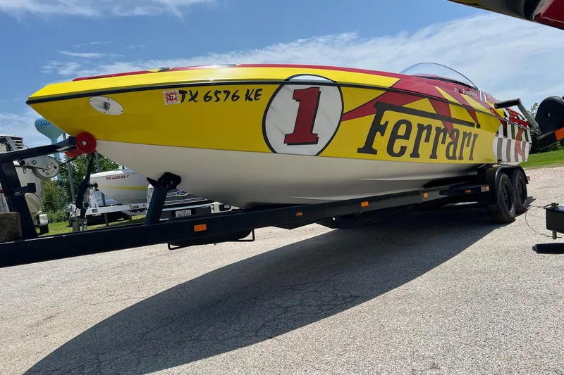 Slide: The Image of Yellow Kachina Drone 26 speedboat with Ferrari branding on a trailer. - 27