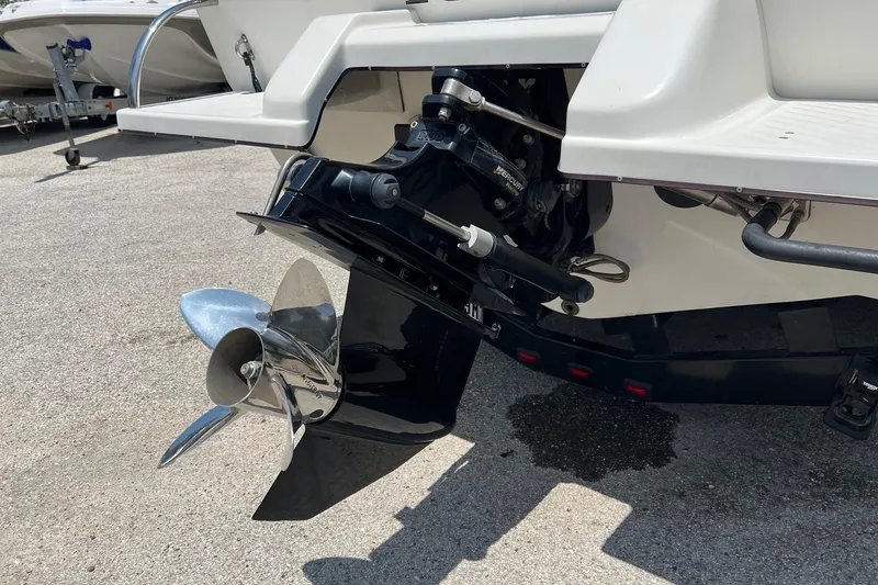 Slide: The Image of Rear view of a 2006 Kachina Drone 26 boat with a shiny propeller. - 28