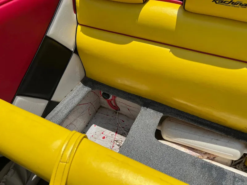 Slide: The Image of Interior of a 2006 Kachina Drone 26 boat with vibrant yellow and red seating. - 4