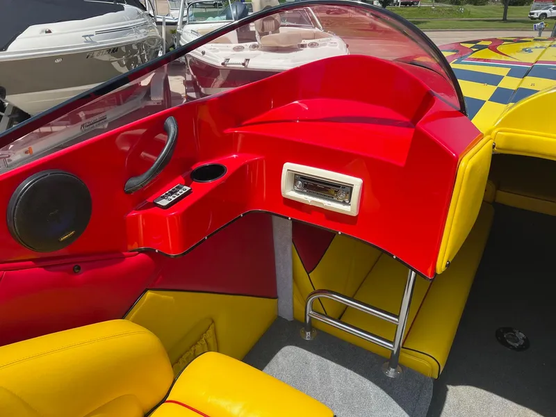 Slide: The Image of Red and yellow interior of a 2006 Kachina Drone 26 boat with modern dashboard design. - 6