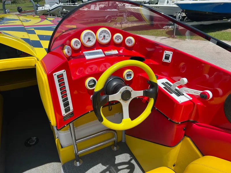 Slide: The Image of Vibrant red and yellow dashboard of a 2006 Kachina Drone 26 boat. - 7