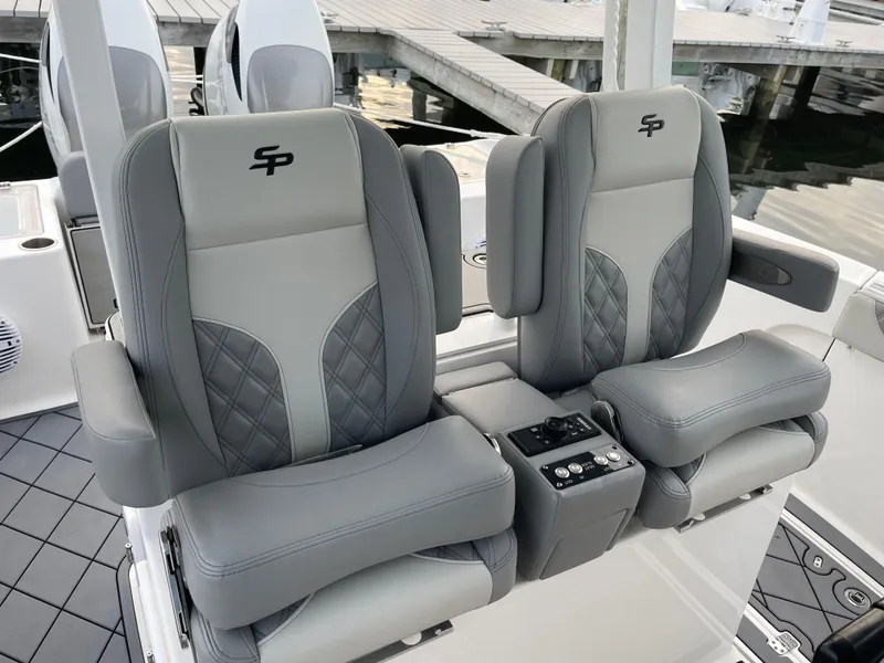 Slide: The Image of 2023 Sea Pro 320 DLX Offshore boat seats with gray upholstery and armrests. - 10